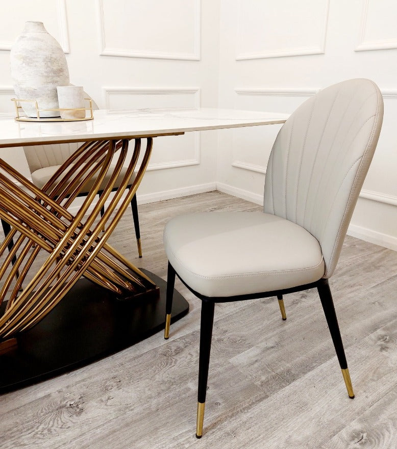 The Orion Dining Table with chairs with white sintered stone top and gold base, upscale home furnishings elegant dining sets, premium tables, marble tables,