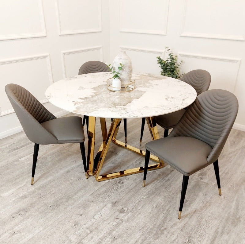 The Titus Dining Table statement dining set, boasting a 140cm tabletop marble effect veneer, sleek black legs, leather chairs, full luxury dining set