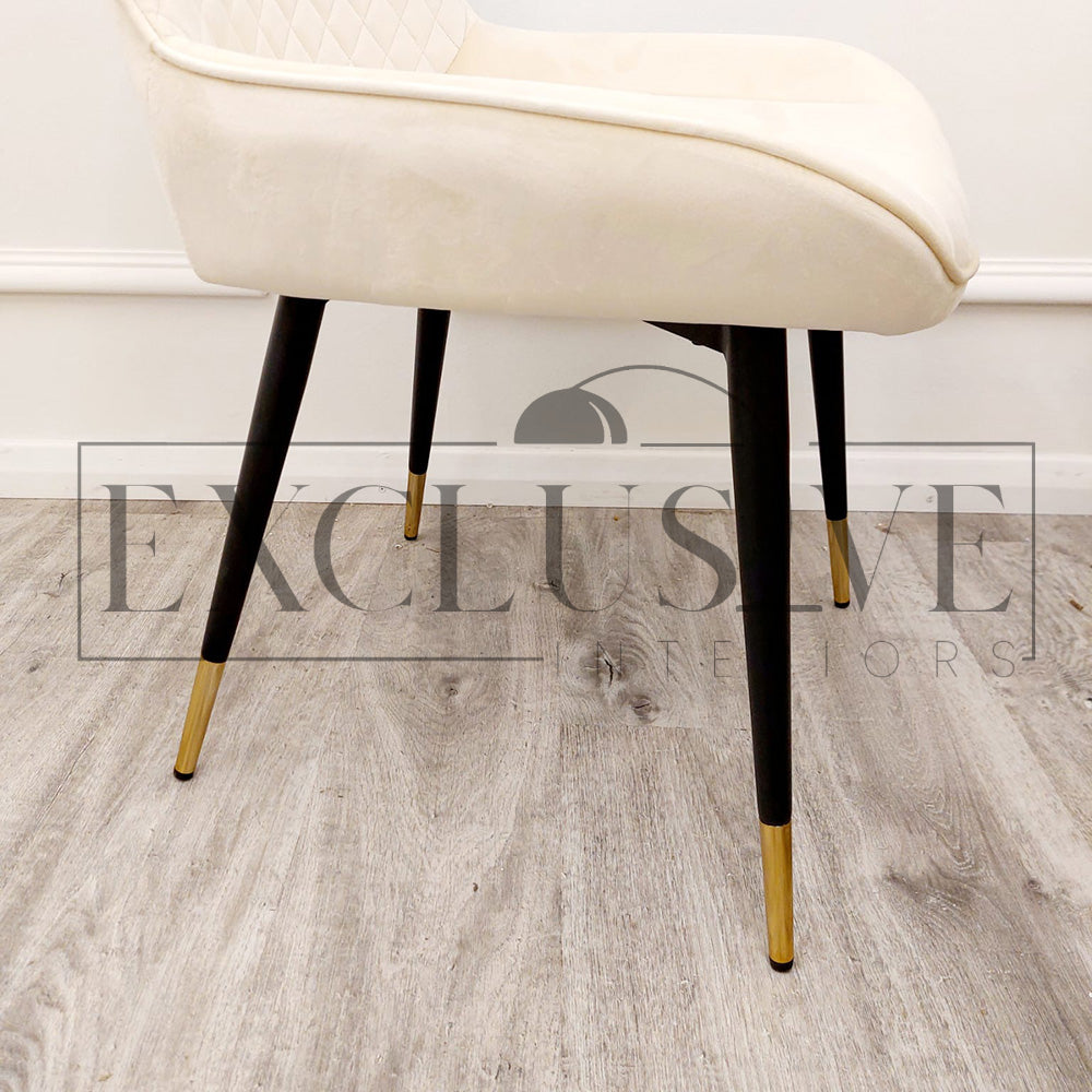 Beautiful Luna Velvet Dining Chair Scandinavian style cross stitch back detail gold tipped black legs. Comfortable luxury chairs, opulent dining chairs styles in cream 