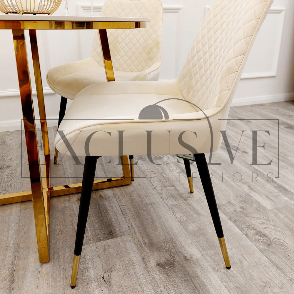 Beautiful Luna Velvet Dining Chair Scandinavian style cross stitch back detail gold tipped black legs. Comfortable luxury chairs, opulent dining chairs styles in cream