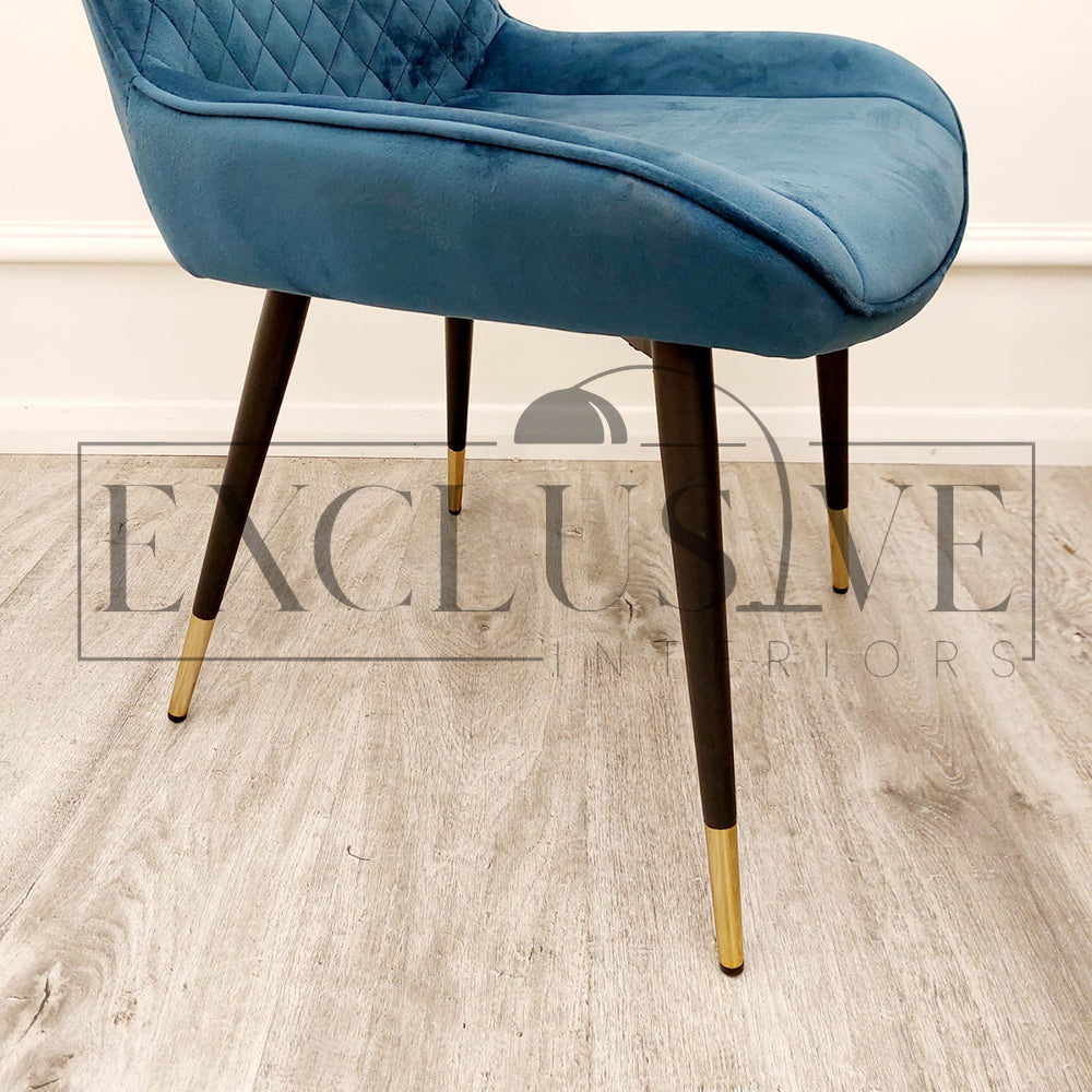 Beautiful Luna Velvet Dining Chair Scandinavian style cross stitch back detail gold tipped black legs. Comfortable luxury chairs, opulent dining chairs styles in blue