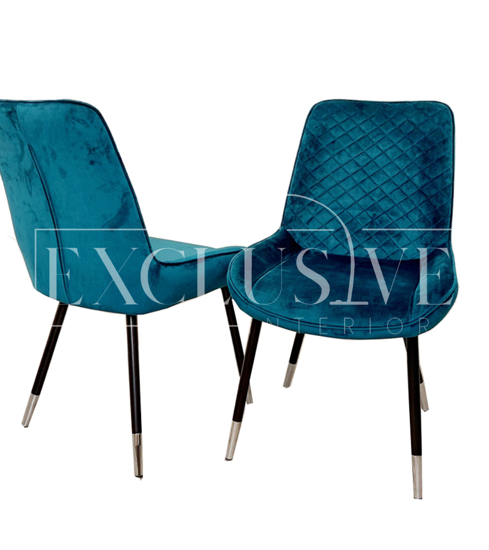 Beautiful Luna Velvet Dining Chair Scandinavian style cross stitch back detail gold tipped black legs. Comfortable luxury chairs, opulent dining chairs styles in teal